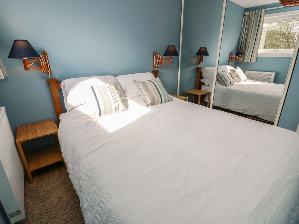 A bedroom with a bed and bedside table at 15 Laigh Isle