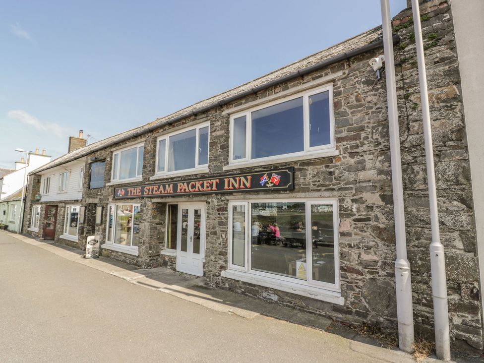 A building exterior with windows and a sign at The Steam Packet Inn in 