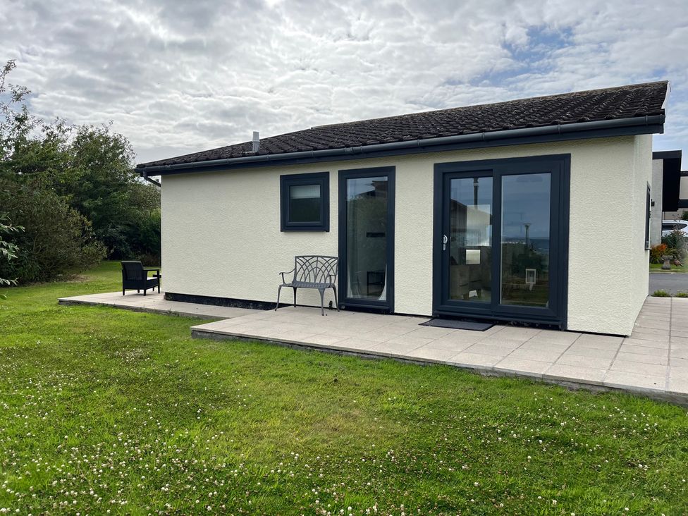 A house with a patio and chairs at 15 Laigh Isle Whithorn