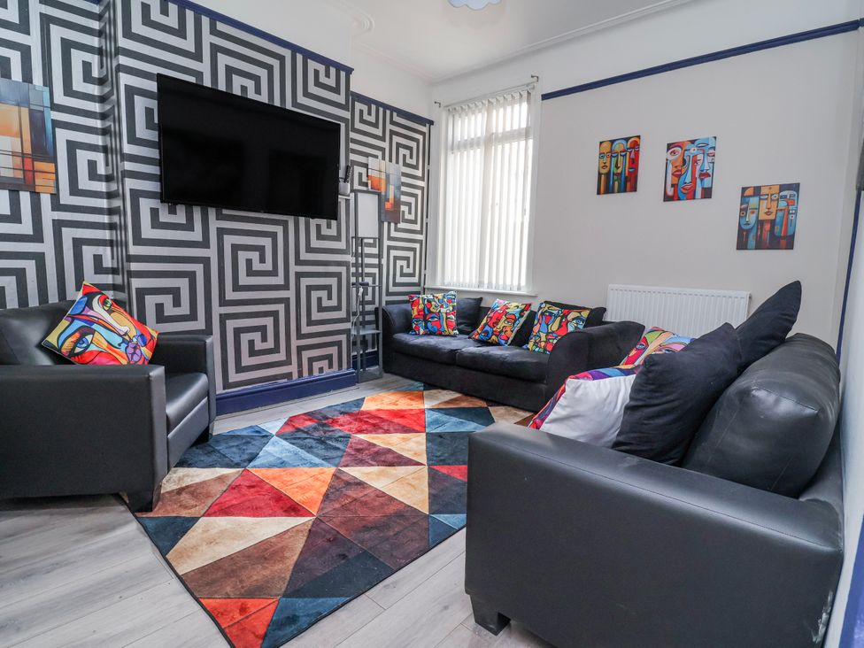 A living room with a sofa and television at Ince Lodge in Liverpool