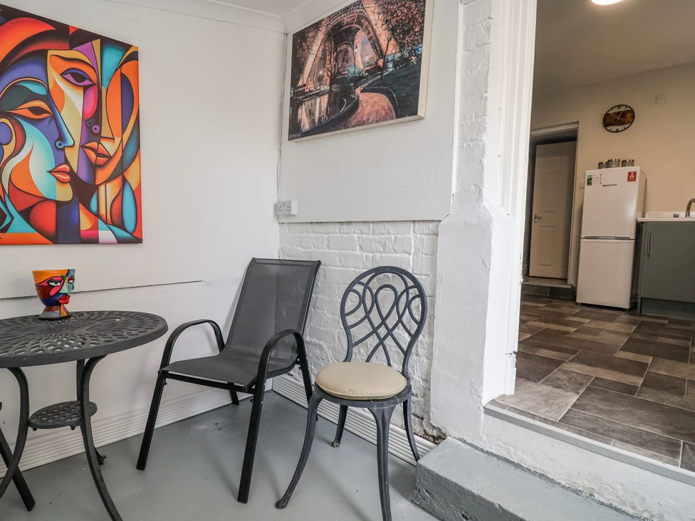 A seating area with a table and chairs at Ince Lodge Liverpool