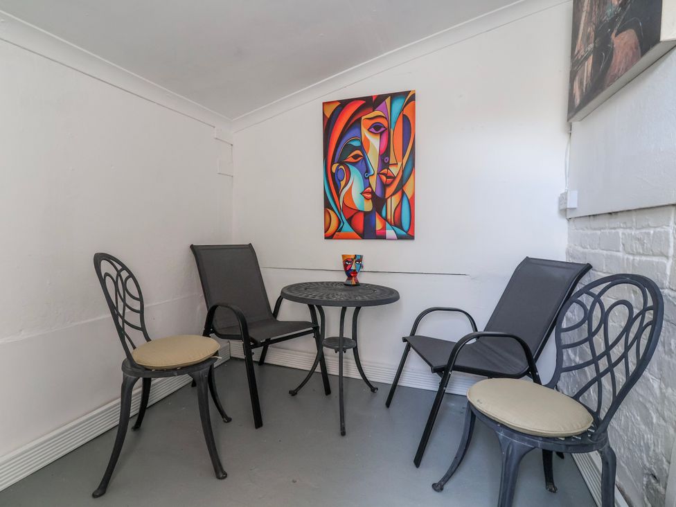 A snug area with a table and chairs at Ince Lodge in Liverpool