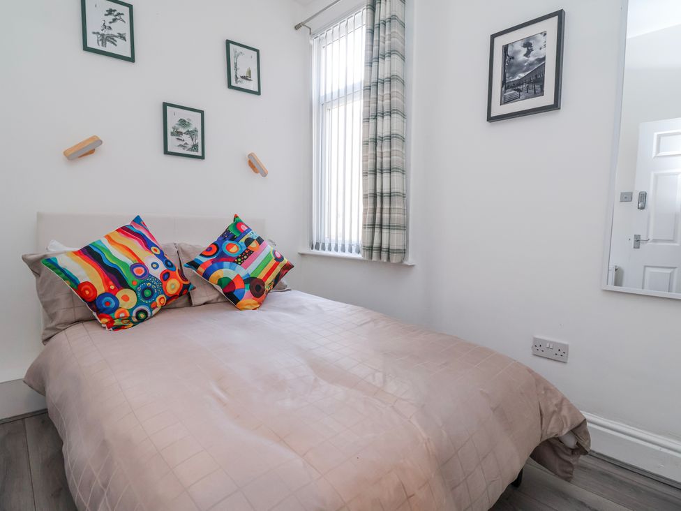 A bedroom with a bed and decorative pillows at Ince Lodge in Liverpool