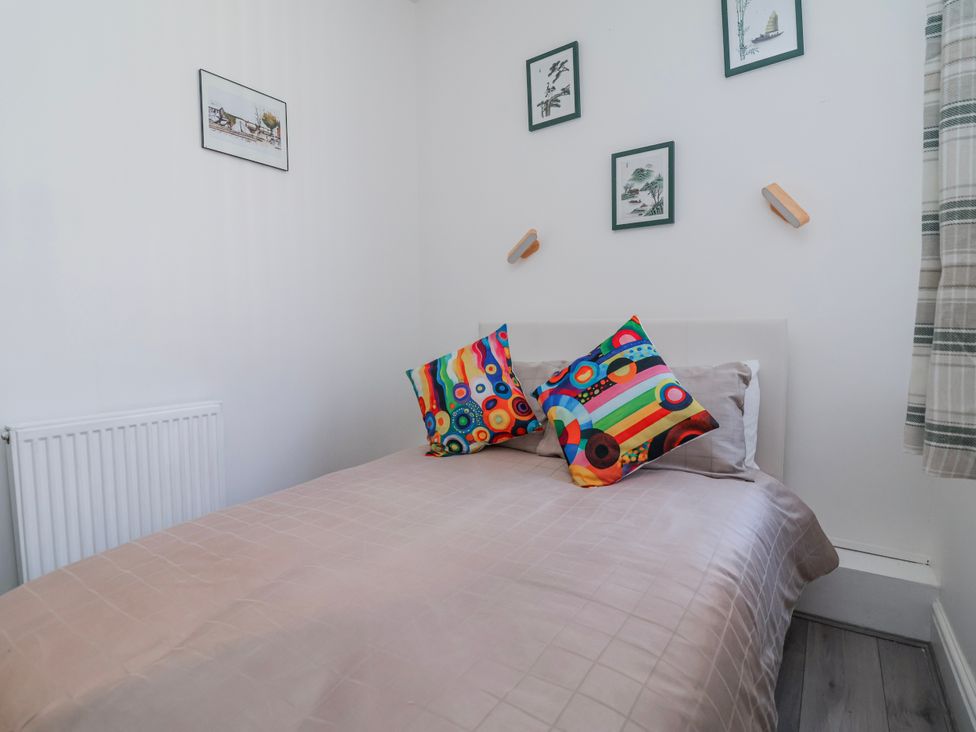 A bedroom with a bed and decorative pillows at Ince Lodge Liverpool