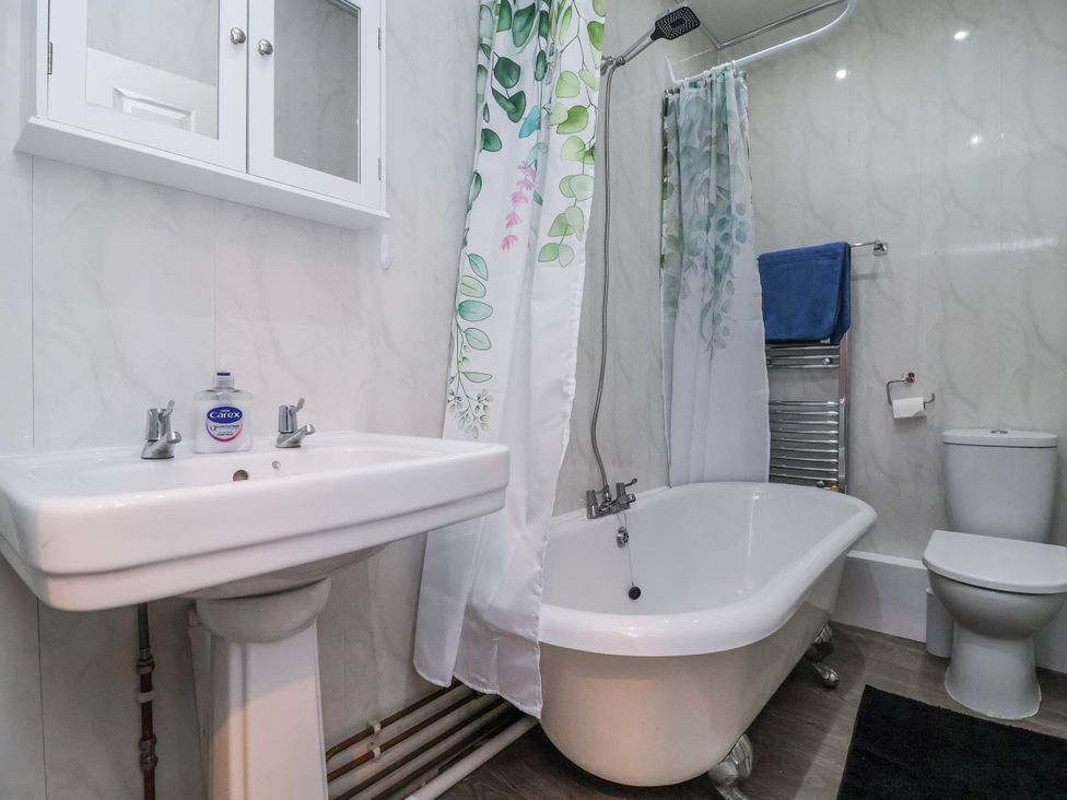 A bathroom with a bathtub and sink at Ince Lodge Liverpool