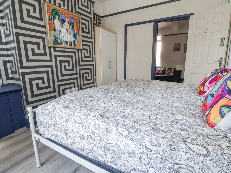 A bedroom featuring a bed with decorative pillows at Ince Lodge Liverpool