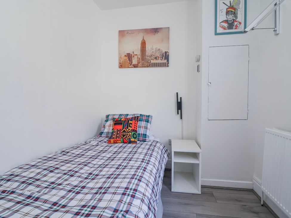 A bedroom with a bed and wall art at Ince Lodge Liverpool