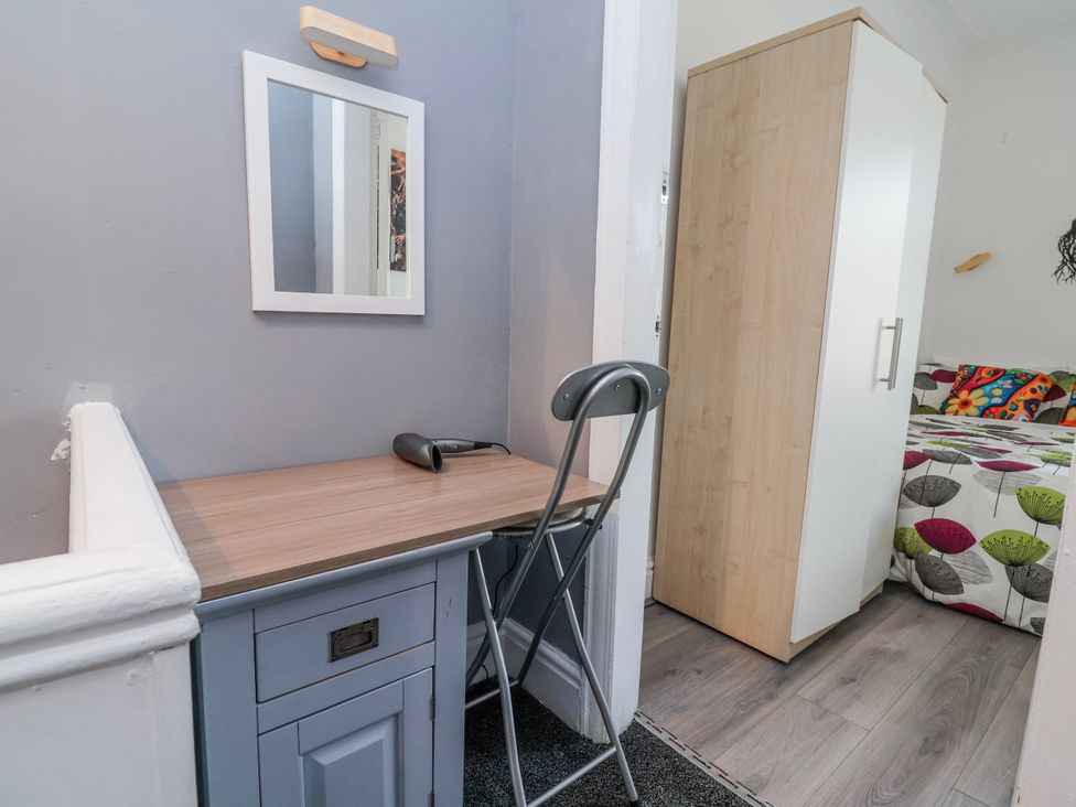 A bedroom with a desk and a wardrobe at Ince Lodge in Liverpool