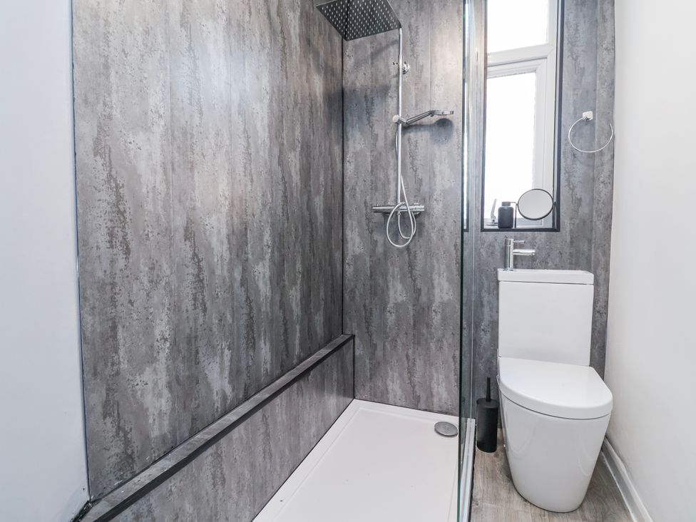 A bathroom with a shower and toilet at Ince Lodge in Liverpool