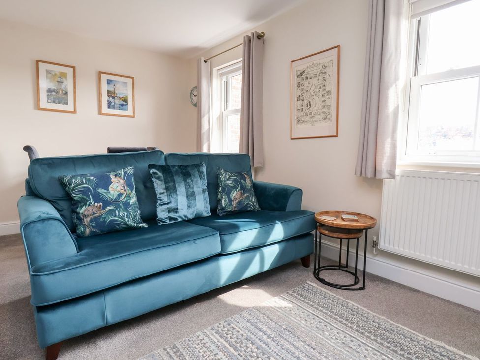 A living room with a sofa and side table at Rails End