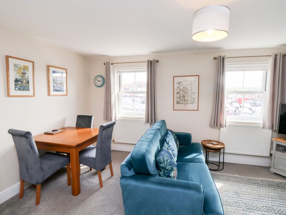 A living room with a dining table and sofa at Rails End