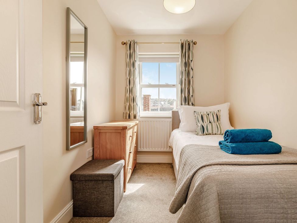 A bedroom with a bed and mirror at Rails End