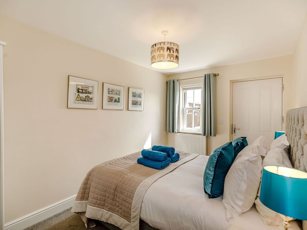 A bedroom with a bed and wall art at Rails End