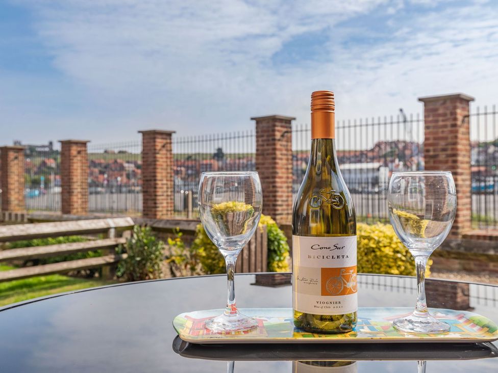 A bottle of wine and glasses on a tray at Rails End