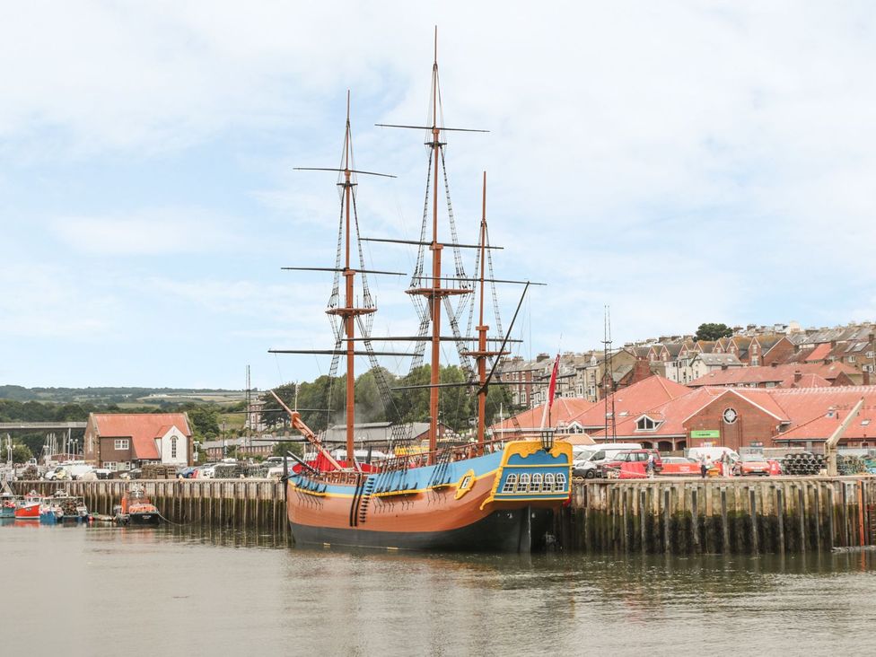 A ship docked at the harbor with buildings in the background at Rails End