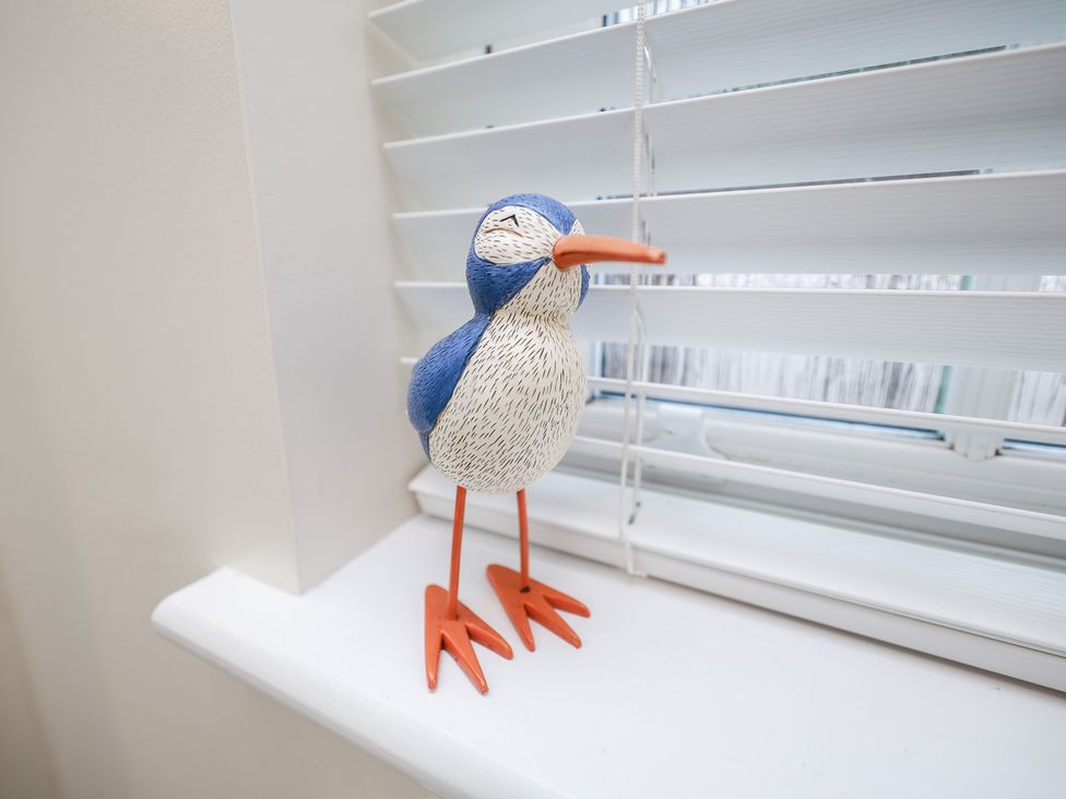 A bird figurine on a window sill at Rails End in Whitby