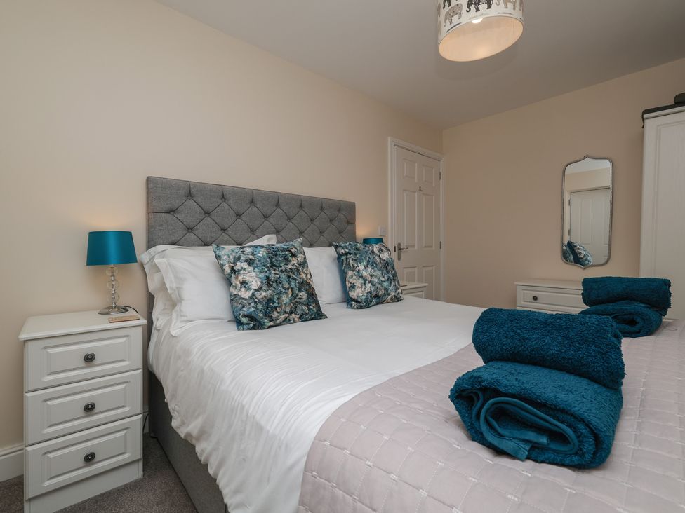 A bedroom with a bed and nightstand at Rails End in Whitby