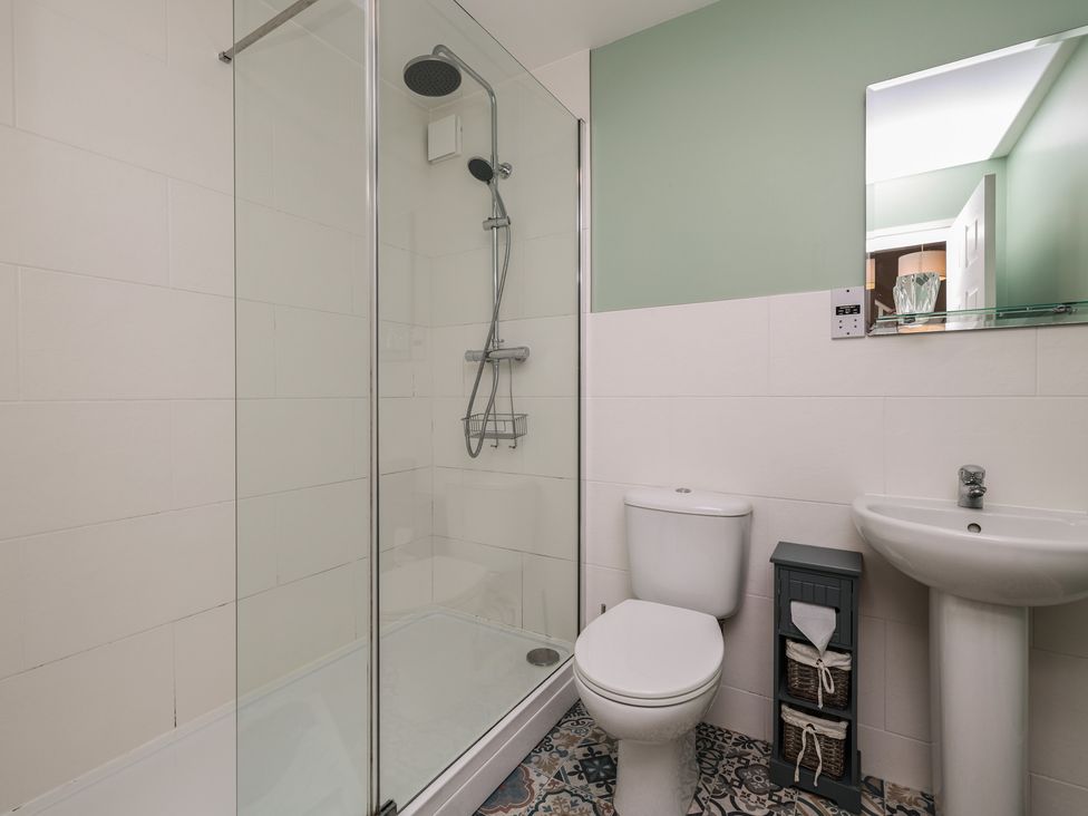 A bathroom with a shower, toilet and sink at Rails End in Whitby