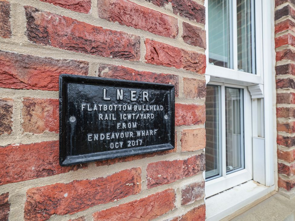 A plaque mounted on a brick wall at Rails End in Whitby