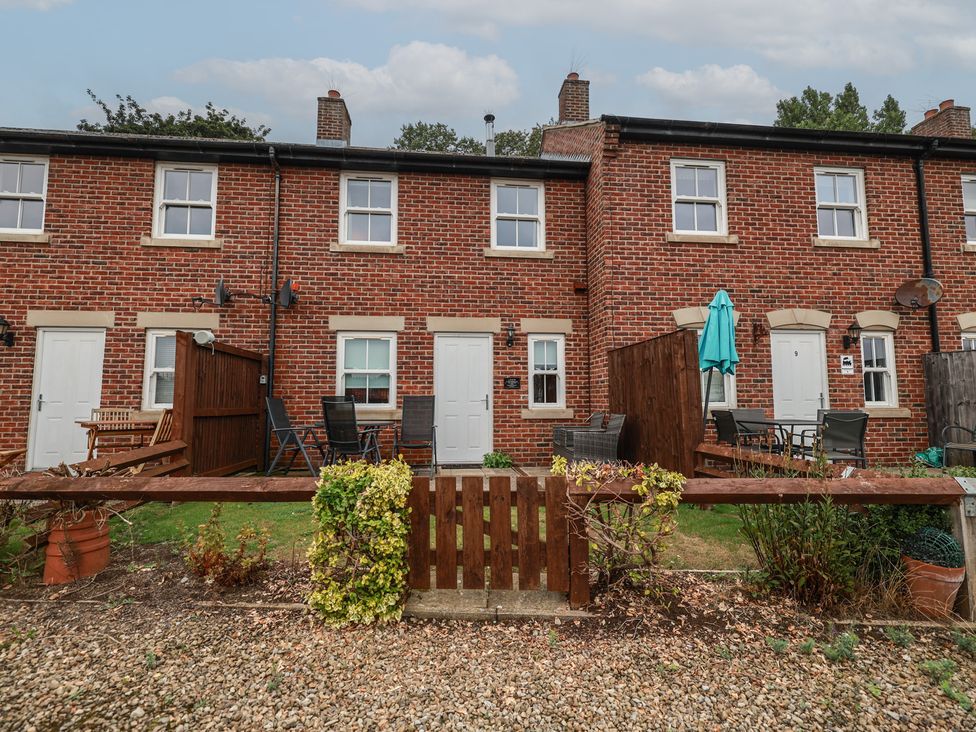 An outdoor area with patio furniture and plants at Rails End in Whitby