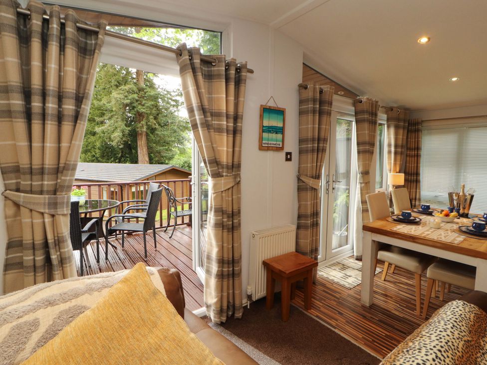 A dining area with a table and chairs at Jodene Lodge, Redwood 2, Bowness-On-Windermere