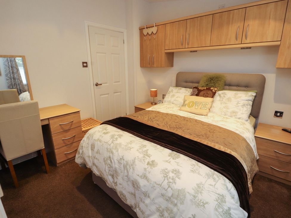 A bedroom with a bed and furniture at Jodene Lodge, Redwood 2 Bowness-On-Windermere