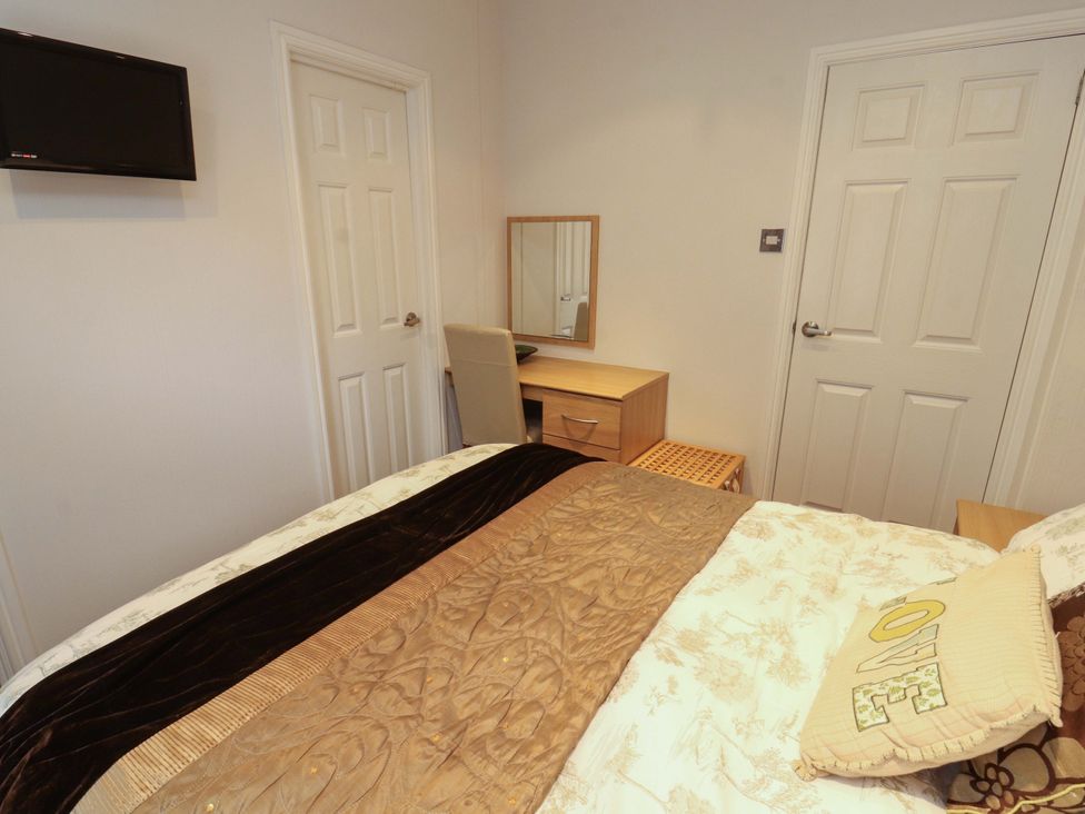 A bedroom with a bed and desk at Jodene Lodge, Redwood 2 Bowness-On-Windermere