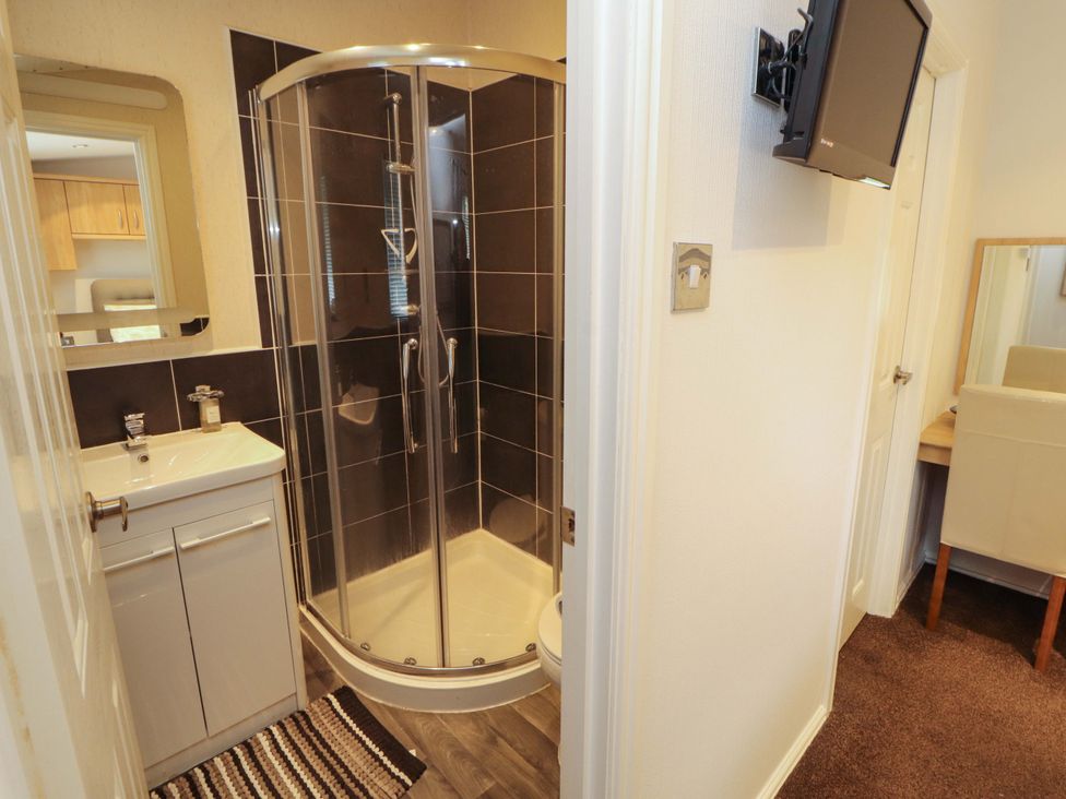 A bathroom with a shower and sink at Jodene Lodge, Redwood 2 Bowness-On-Windermere