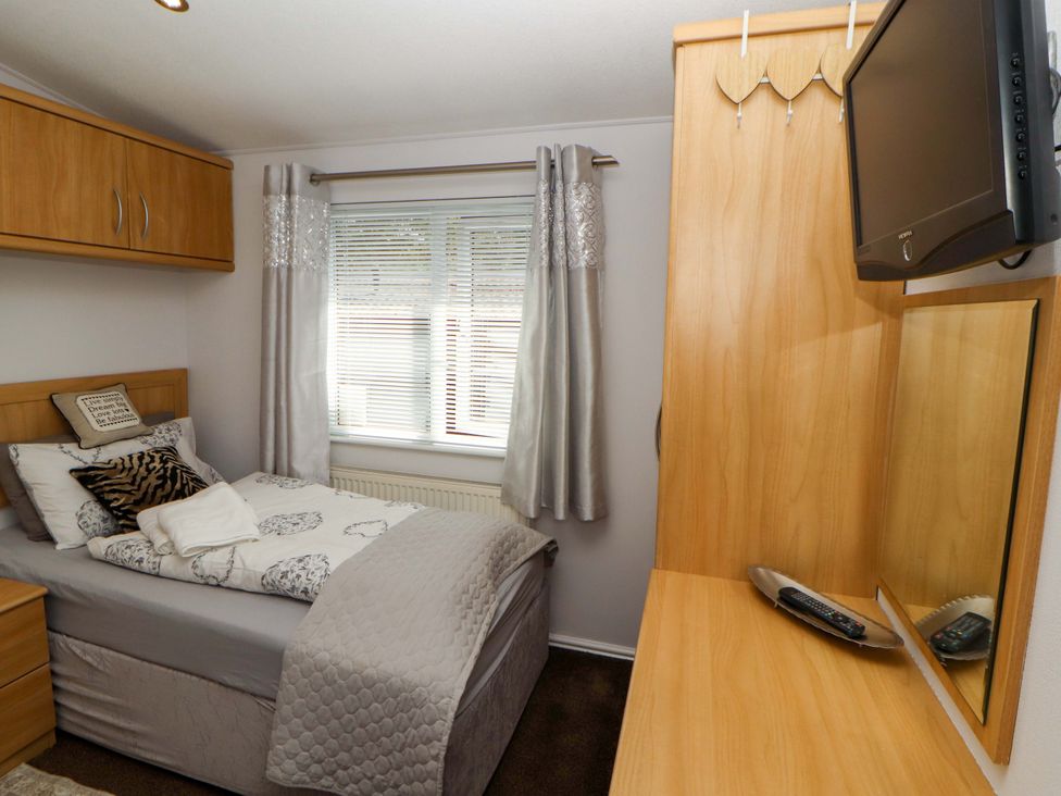 A bedroom with a single bed and a television at Jodene Lodge, Redwood 2 Bowness-On-Windermere