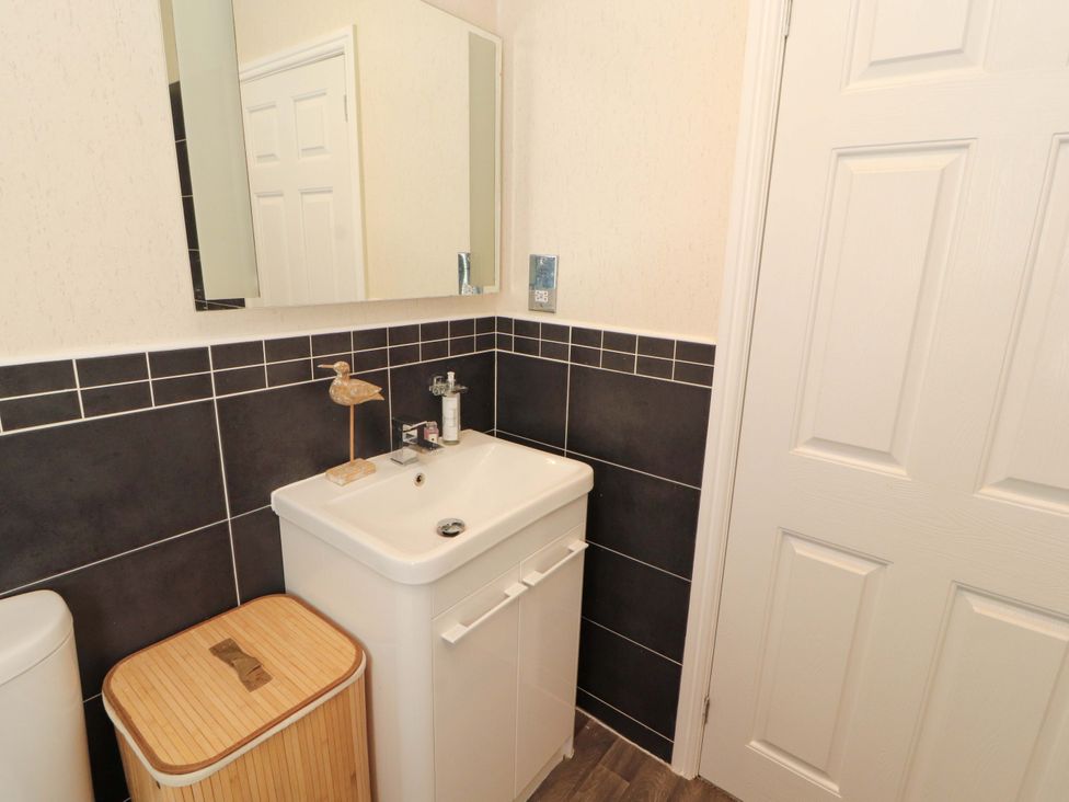 A bathroom with sink and mirror at Jodene Lodge, Redwood 2 Bowness-On-Windermere