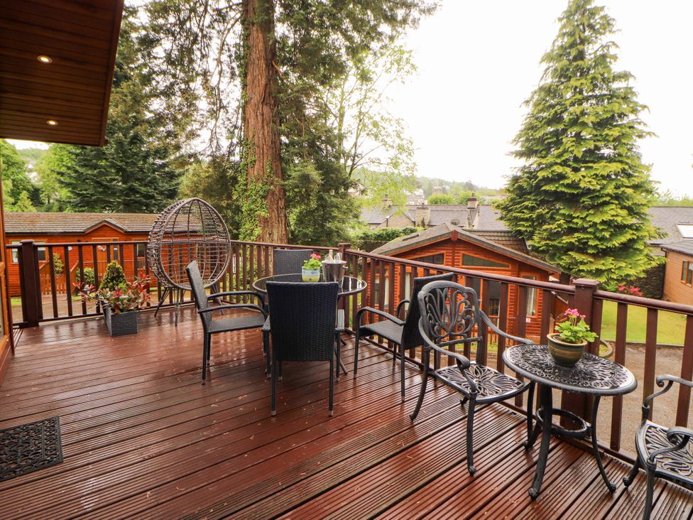 A deck with seating and plants at Jodene Lodge, Redwood 2 Bowness-On-Windermere