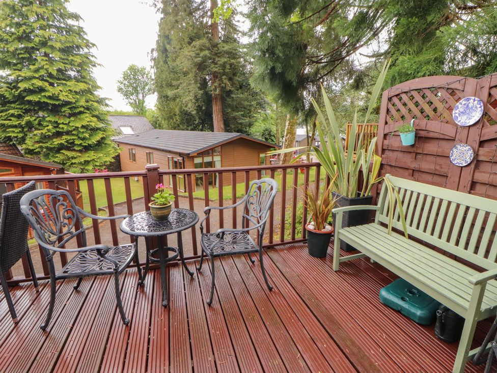 A deck with a table and chairs at Jodene Lodge, Redwood 2, Bowness-On-Windermere