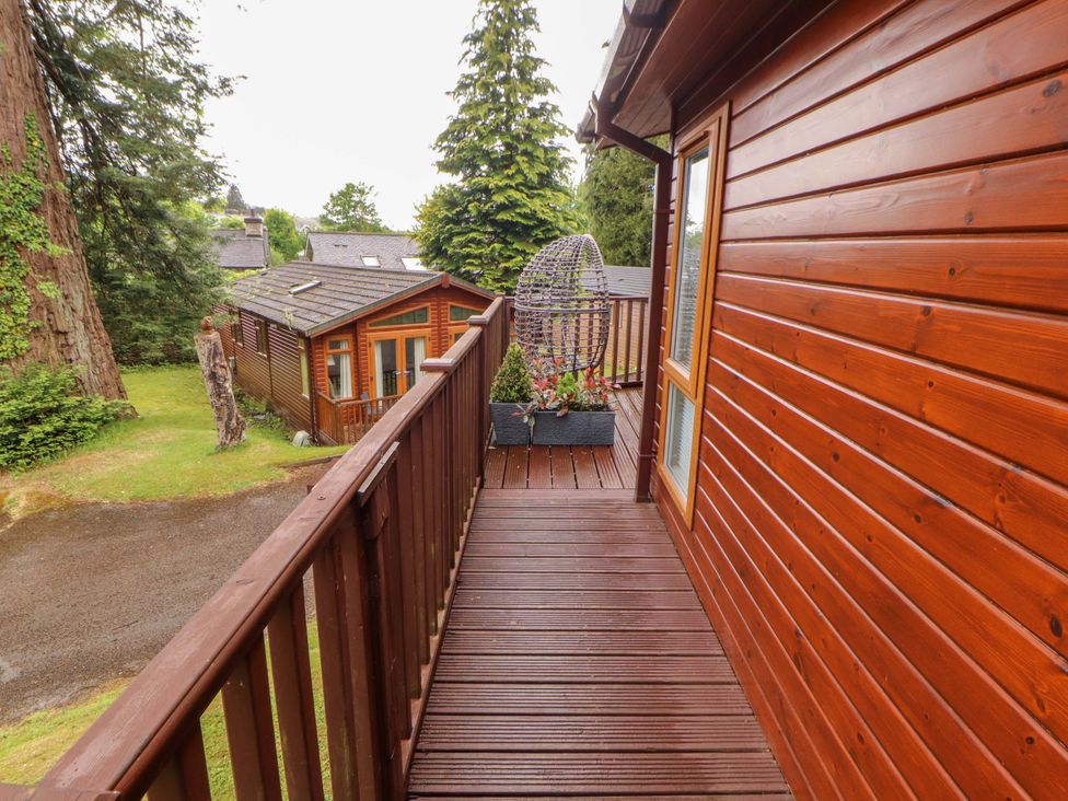 An outdoor deck with a hanging planter at Jodene Lodge, Redwood 2 Bowness-On-Windermere