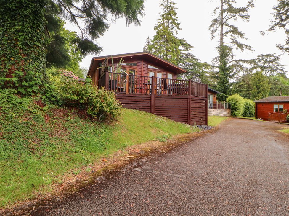 A lodge with a deck and pathway at Jodene Lodge, Redwood 2 Bowness-On-Windermere