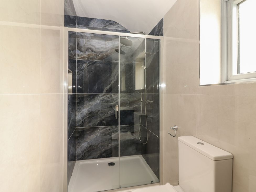 A bathroom with a shower and toilet at 17 ROOSKA, Lisdoonvarna, County Clare