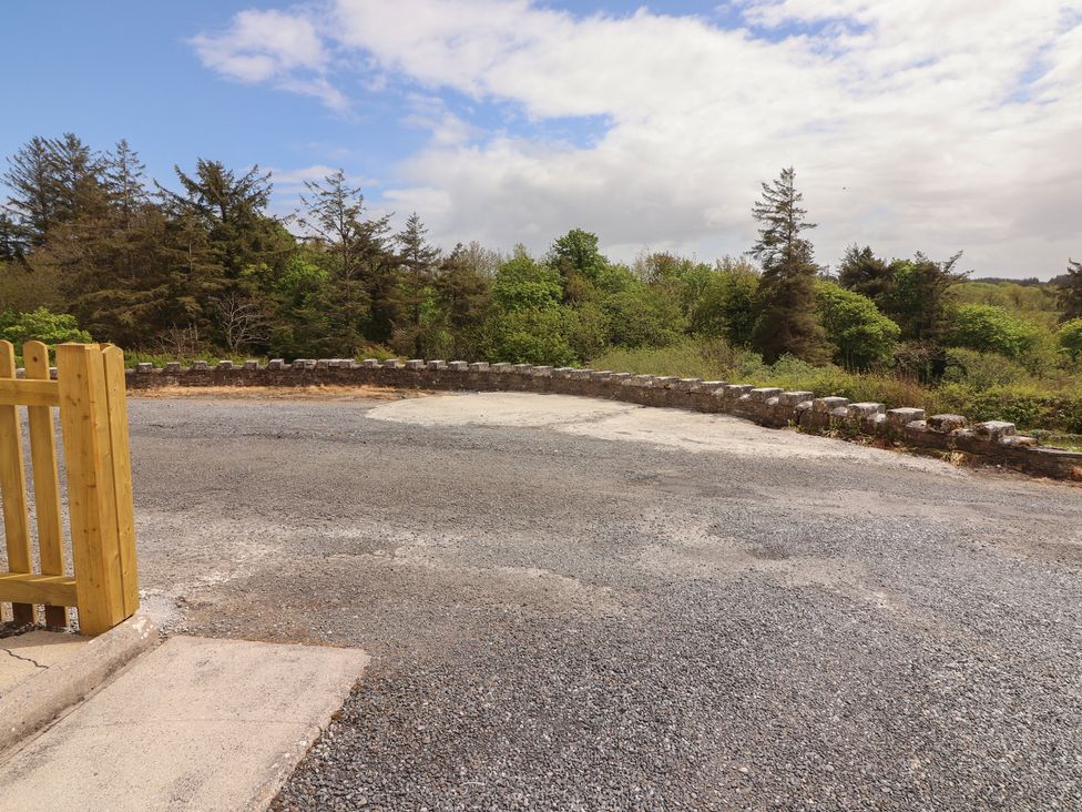 An outdoor area with a gravel surface and a fence at 17 ROOSKA, Lisdoonvarna, County Clare