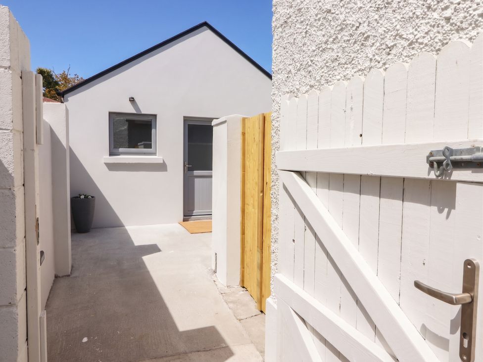 An outdoor area with a white wall and a door at 17 ROOSKA, Lisdoonvarna, County Clare