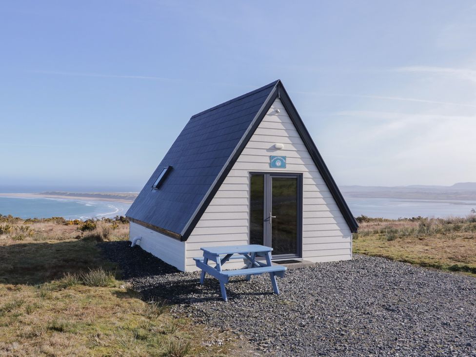 A cabin with a sloped roof and table at Cabin 2 Min Larach in Gortahawk