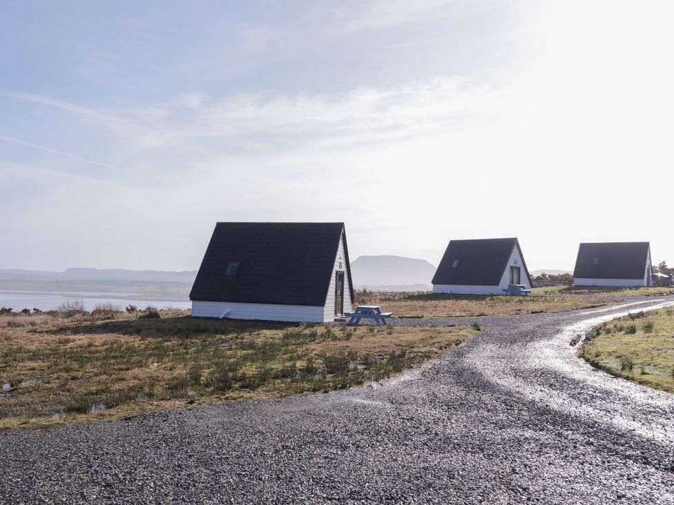 A view of multiple houses next to a road at Cabin 2 Min Larach in Gortahawk