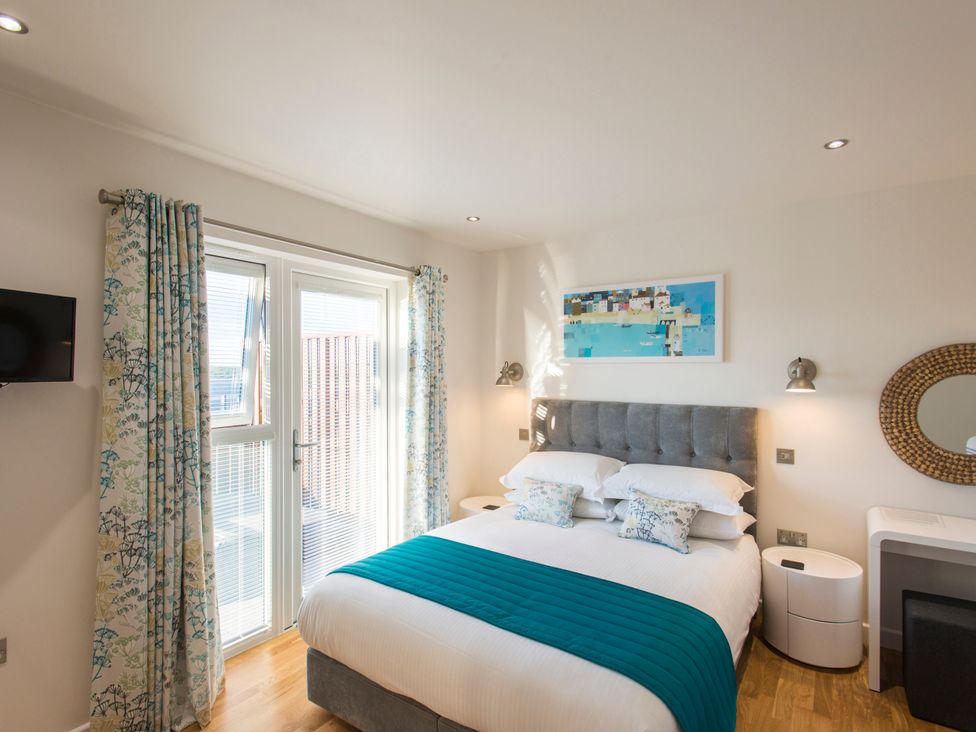 A bedroom with a bed and window at Barbara in Portreath