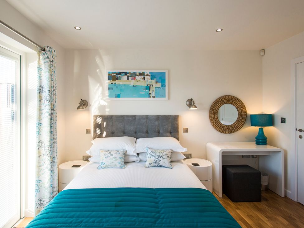 A bedroom with a bed and decorative items at Barbara in Portreath