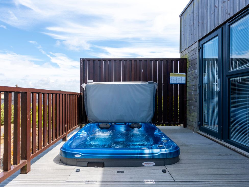 A hot tub on a deck in an outdoor area at Barbara in Portreath