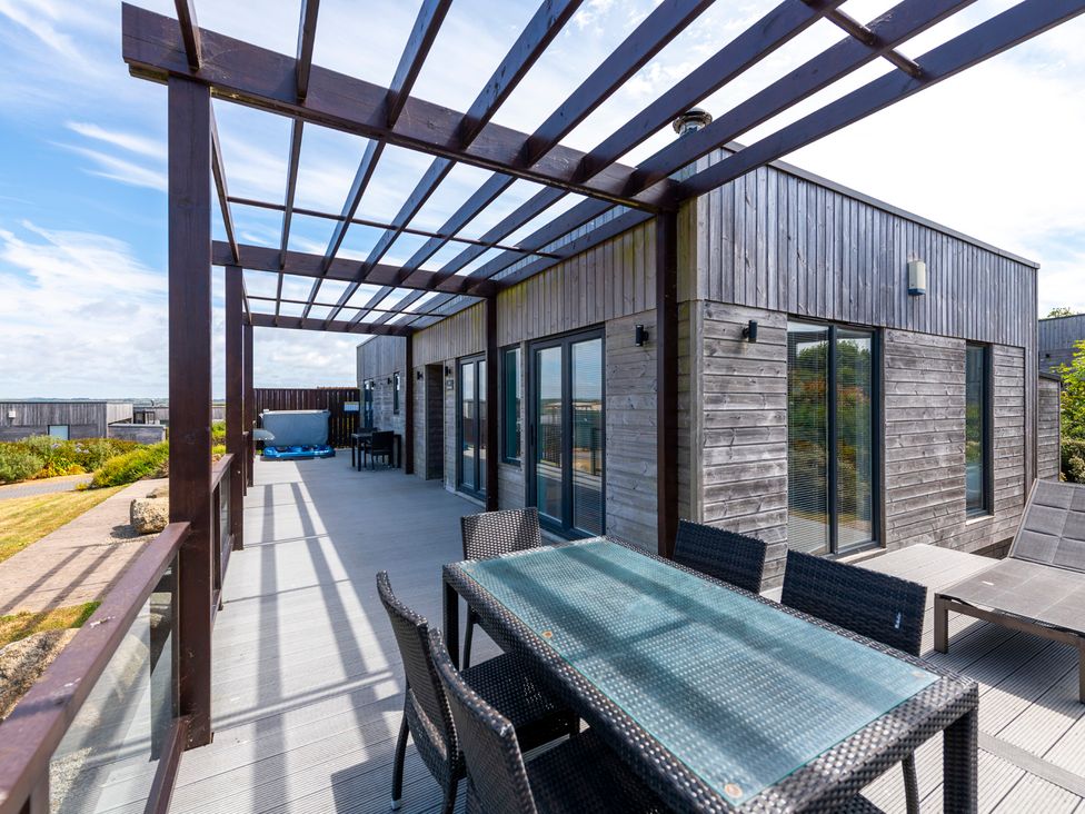 An outdoor patio with a table and chairs at Barbara in Portreath