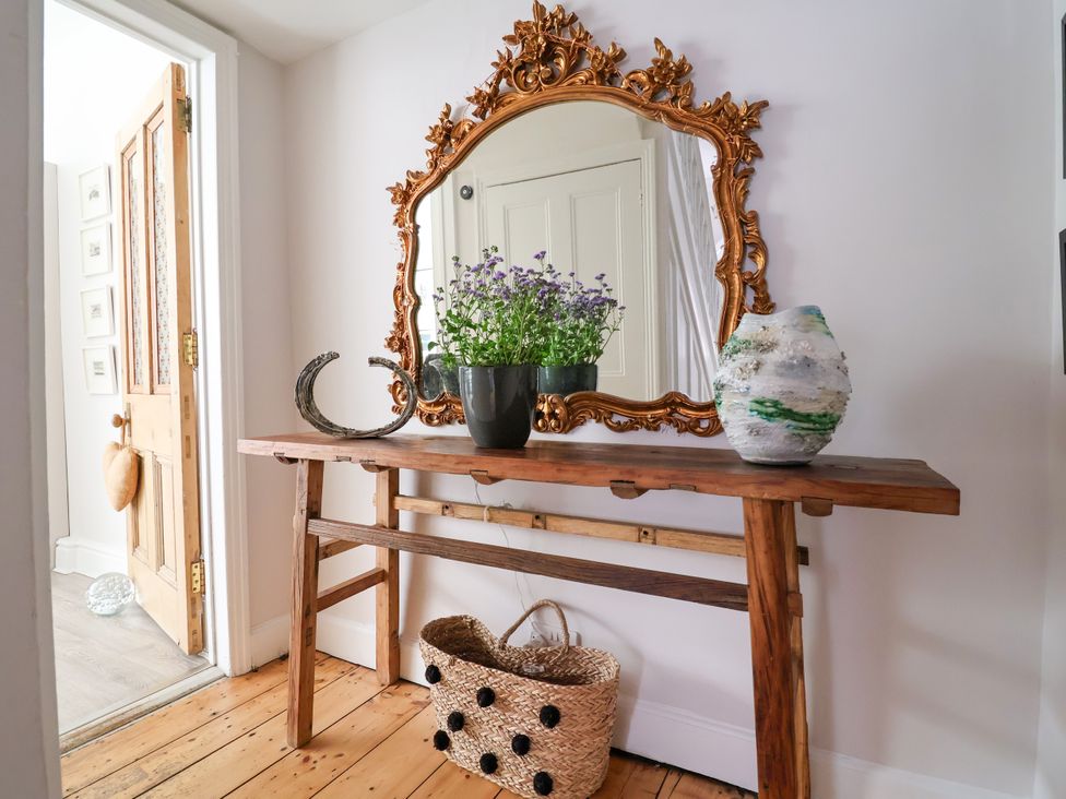A hallway with a mirror and table at 34 Eaton Road, Chester