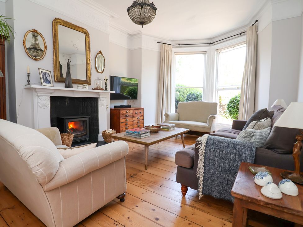 A living room with a sofa and television at 34 Eaton Road Chester