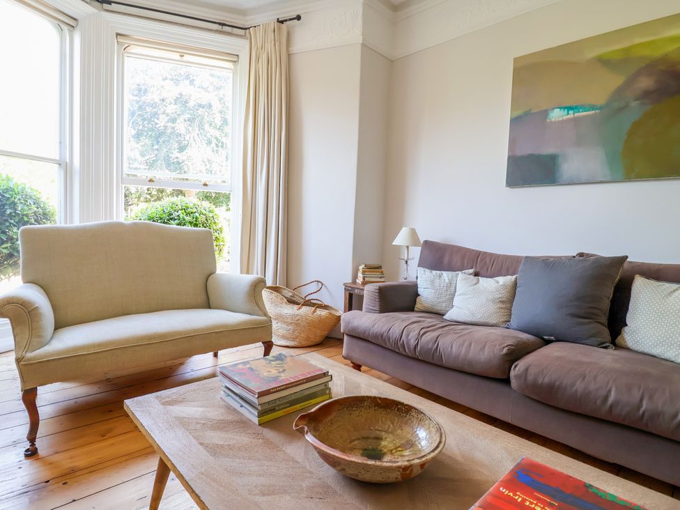 A living room with a sofa and armchair at 34 Eaton Road in Chester