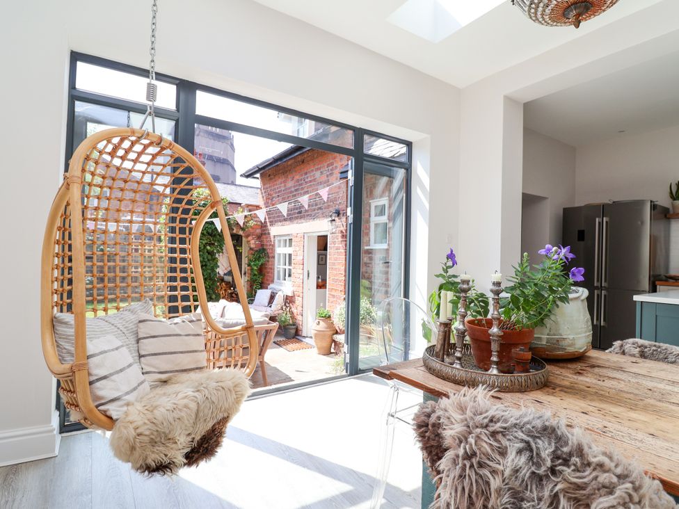 A kitchen with a hanging chair and potted plants at 34 Eaton Road in Chester