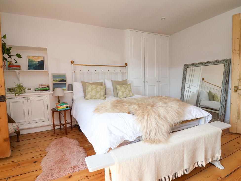 A bedroom with a bed and mirror at 34 Eaton Road, Chester