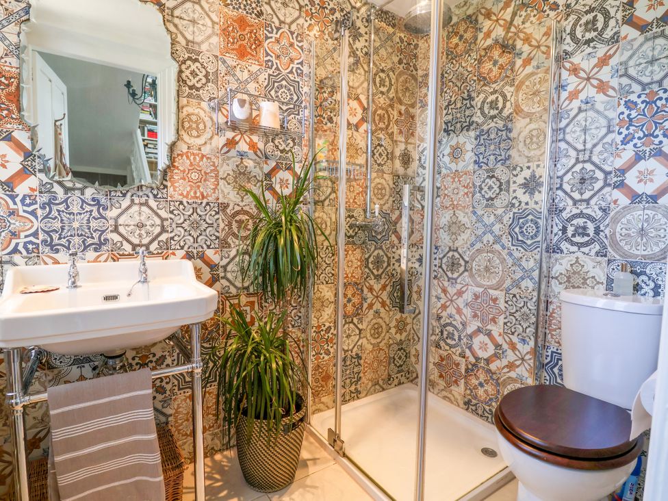 A bathroom with a shower, sink, and toilet at 34 Eaton Road Chester