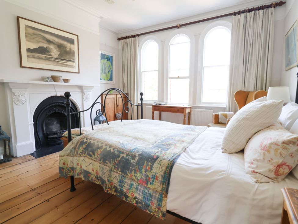A bedroom with a bed and a fireplace at 34 Eaton Road Chester